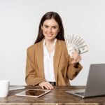 Beginner making first $100 online using laptop with digital income dashboard and online earning methods